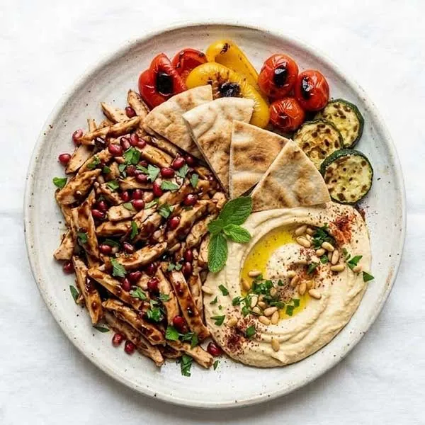 Lebanese pomegranate molasses chicken with charred vegetables & hummus
